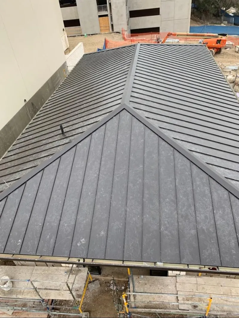 Commercial metal roof construction with crane equipment in Oak Hills