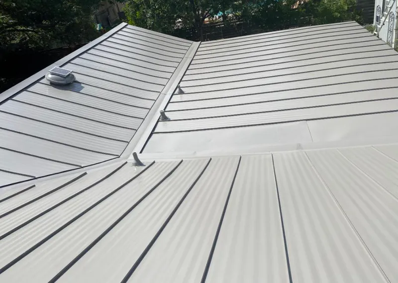 Solar attic fan installed on a metal roof for Roof Ventilation in Oak Hills